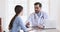 Smiling male doctor handshake female patient expressing trust concept