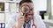 Smiling male doctor looks through magnifying glass 4k movie