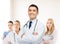 Smiling male doctor in white coat at hospital