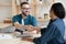 Smiling male employer handshake female job candidate at meeting