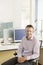 Smiling Male Executive Sitting At Desk