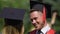 Smiling male graduate talking to friend at graduation party, happiness and joy