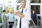 Smiling Male Physiotherapist Holding Clipboard In Fitness Center