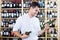 Smiling male professional wine expert holding wine bottles