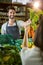 Smiling male staff assisting a woman with grocery shopping