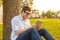 Smiling male student in eyeglasses with tablet pc