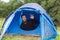 Smiling male tourist with beard in tent