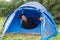 Smiling male tourist with beard in tent