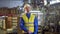 Smiling male worker in the functioning factory facility