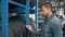 Smiling man auto mechanic carrying new tire in tire store choosing for his car