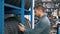 Smiling man auto mechanic carrying new tire in tire store choosing for his car