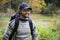 Smiling Man With Backpack Hiking In Forest