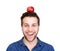 Smiling man balancing apple on head