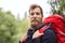 Smiling man with beard and backpack hiking