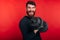 Smiling man with beard looking at the camera and working with dumbbell