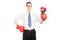 Smiling man with boxing gloves holding a bunch of flowers