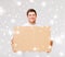 Smiling man carrying carton box