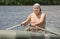 Smiling man enjoying a row in a rubber dinghy