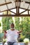 Smiling man exercising under shed at yard