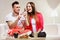 Smiling man feeding happy woman with cake.