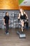 Smiling man fitness coach instructor in a gym with blonde fit sporty woman