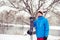 Smiling man in a funny hat with snowboard