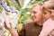 Smiling man with girl buy parsley in supermarket