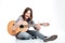 Smiling man with guitar sitting and doing rock gesture
