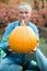 Smiling man holding a pumpkin in his hands
