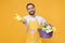 Smiling man househusband in apron rubber gloves hold basin with detergent bottles washing cleansers doing housework