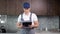 Smiling man plumber inspects records on clipboard in kitchen