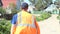 Smiling Man Puts on Orange Vest and Goes Away on Dirty Road