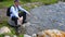 Smiling man resting near river in Tian Shan mountains, Kyrgyzstan