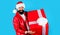 Smiling man in Santa hat with big gift box. New year present. Christmas holiday. Delivery gifts.
