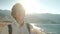 Smiling man standing on beach in summer day.