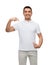 Smiling man in t-shirt pointing fingers on himself