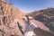 Smiling man taking selfie at volcanic rock formation known as