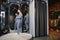 Smiling man trying on suit at mirror in menswear shop