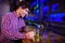 Smiling man using laptop at bar counter