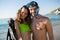 Smiling man wearing scuba mask while standing with girlfriend at beach