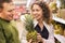 Smiling man and woman buy pineapple in supermarket