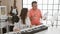 Smiling man and woman musicians engrossed in their music studio lesson, harmonizing melodies on acoustic piano while singing