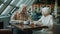 Smiling man and woman of old age talking and drinking tea in modern cafe