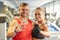 Smiling man and woman showing ok hand sign in gym