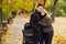 Smiling man and woman stand embracing near