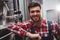 Smiling manufacturer standing by storage tank in brewery