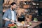 smiling mature bearded man preparing vegetable salad