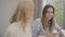 Smiling mature Caucasian woman telling funny story to her guests. Family gathered at the table, drinking tea and