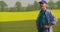 Smiling Mature Farmer Examining Agricultural Field