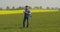 Smiling mature farmer examining agricultural field